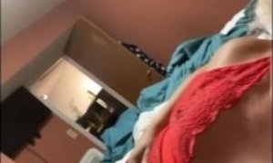 Sexy trans MILF shows off breasts in red lingerie and plays with dildo