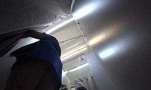 A covert camera in the fitting guest room caught a big-boobed cougar with ample hips. Mature butt in undies under a mini-skirt.