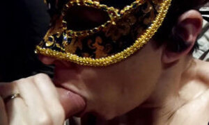 A masked MILF in sexy lingerie sucks her husband's cock and plays with his cum in her mouth.