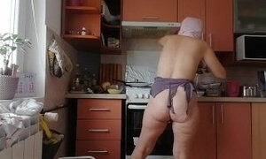 Sexy naked wife prepares food in the kitchen. Hairy brunette hair, big ass, big tits.