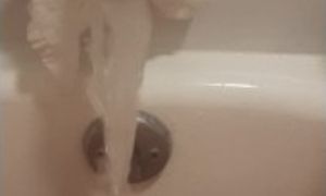 Chubby blonde cums using bathtub faucet