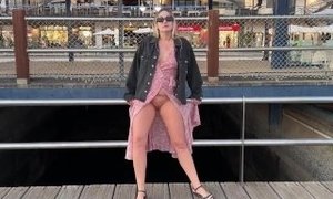 Blonde girl walking on the street and flashing pussy on public