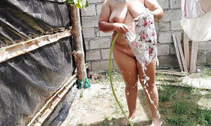Sexy Colombian girl bathes in a public place and touches her pussy and tits very richly.