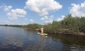Naked girl riding on SUP board
